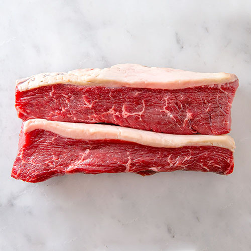 two pieces of meat with fat on it